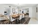 Open dining room with a wooden table, modern light fixture, and views into other rooms at 1000 Kewannee Trl, Maitland, FL 32751