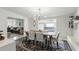 Bright dining room with white walls, views into multiple rooms, and a modern light fixture at 1000 Kewannee Trl, Maitland, FL 32751