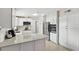 Modern kitchen with white cabinets, stainless steel appliances, and a large center island at 1000 Kewannee Trl, Maitland, FL 32751