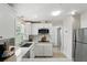 Bright, updated kitchen with stainless appliances, white cabinets, and quartz countertops at 1000 Kewannee Trl, Maitland, FL 32751