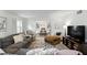 Cozy living room with an open view to the dining area with a fireplace and built-in shelving at 1000 Kewannee Trl, Maitland, FL 32751