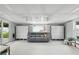 Spacious living room area with a neutral sofa, white cabinets, and a sliding glass door at 1000 Kewannee Trl, Maitland, FL 32751