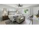 Bright main bedroom featuring a ceiling fan, neutral walls, and a sitting area with a plush upholstered bench at 1000 Kewannee Trl, Maitland, FL 32751