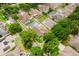 An aerial view of a neighborhood shows well-maintained homes, lush trees, and several private swimming pools at 10001 Newington Dr, Orlando, FL 32836