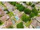 An aerial shot displays a neighborhood with houses, green trees, and private pools enclosed with screens at 10001 Newington Dr, Orlando, FL 32836