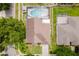 An aerial view showcases this home's roof, screened-in pool, and the surrounding green landscaping at 10001 Newington Dr, Orlando, FL 32836