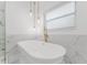 Elegant freestanding bathtub with gold fixtures and marble surround at 10001 Newington Dr, Orlando, FL 32836