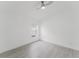 Bright bedroom featuring light hardwood floors, a ceiling fan, and a window for natural light at 10001 Newington Dr, Orlando, FL 32836