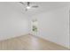 Bright bedroom with hardwood floors, a modern ceiling fan, and a window offering natural light at 10001 Newington Dr, Orlando, FL 32836