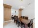 This contemporary dining room features a wood dining table, modern lighting, and stylish wood paneled accent walls at 10001 Newington Dr, Orlando, FL 32836