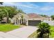 The exterior of this well-maintained home features a neutral color palette and an attached two-car garage at 10001 Newington Dr, Orlando, FL 32836