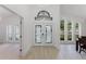 Bright foyer with decorative glass double doors and windows at 10001 Newington Dr, Orlando, FL 32836