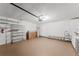 Well-lit garage with epoxy floors, showcasing organized storage shelves and plenty of open space at 10001 Newington Dr, Orlando, FL 32836