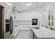 Bright kitchen featuring sleek white cabinetry, stainless steel appliances, and a large island with seating at 10001 Newington Dr, Orlando, FL 32836