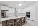 Modern kitchen with white cabinets, an island with seating, and stainless steel appliances at 10001 Newington Dr, Orlando, FL 32836
