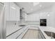 Contemporary kitchen featuring white cabinets, quartz countertops, and stainless steel range hood at 10001 Newington Dr, Orlando, FL 32836