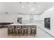 Kitchen featuring white cabinets, stainless steel appliances, and barstool seating at the island at 10001 Newington Dr, Orlando, FL 32836