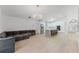 Open-concept living space with a kitchen, island, and comfortable gray sectional sofa at 10001 Newington Dr, Orlando, FL 32836