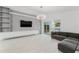 Spacious living room with gray entertainment center and sofa, with pool view from sliding glass doors at 10001 Newington Dr, Orlando, FL 32836