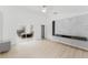 Open-concept living room with hardwood floors and marble accent wall featuring built in storage at 10001 Newington Dr, Orlando, FL 32836