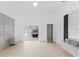 Bright living room with hardwood floors, adjacent to bathroom with marble accent wall with storage at 10001 Newington Dr, Orlando, FL 32836