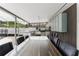 Covered outdoor kitchen with a built-in grill and a long counter with seating at 10001 Newington Dr, Orlando, FL 32836