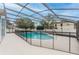 Screened-in pool area with secure fencing and lush landscaping at 10001 Newington Dr, Orlando, FL 32836