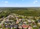 Picturesque aerial view featuring a residential area with lush trees, various home styles, and a scenic highway nearby at 1008 Soldier Creek Ct, Oviedo, FL 32765
