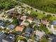 Bird's-eye view of homes with screened pools, solar panels, manicured lawns, and mature trees in a Gathering-friendly neighborhood at 1008 Soldier Creek Ct, Oviedo, FL 32765
