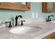Close up of a modern bathroom vanity featuring granite countertop and dark fixtures at 1008 Soldier Creek Ct, Oviedo, FL 32765