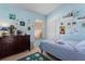 Blue bedroom featuring a closet, a bed, and a chest of drawers at 1008 Soldier Creek Ct, Oviedo, FL 32765