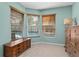 Bright room with pool view through windows, features light blue walls and wood furniture at 1008 Soldier Creek Ct, Oviedo, FL 32765