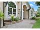 Close-up of the entryway with arched windows and walkway at 1008 Soldier Creek Ct, Oviedo, FL 32765
