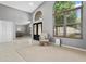 Spacious foyer featuring tile flooring, neutral paint, arched doorway, and a large window at 1008 Soldier Creek Ct, Oviedo, FL 32765