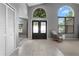 Inviting foyer with high ceilings, tiled flooring, and a view of the front windows at 1008 Soldier Creek Ct, Oviedo, FL 32765