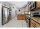 Modern kitchen with stainless steel refrigerator, granite countertops, and ample storage at 1008 Soldier Creek Ct, Oviedo, FL 32765