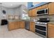 Bright kitchen with granite countertops, stainless steel appliances, and a breakfast bar at 1008 Soldier Creek Ct, Oviedo, FL 32765