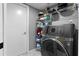 Functional laundry room with gray washer and dryer, shelving, and plenty of storage space at 1008 Soldier Creek Ct, Oviedo, FL 32765