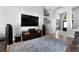 Well-lit living room features entertainment center, hardwood floors, and stylish decor at 1008 Soldier Creek Ct, Oviedo, FL 32765