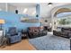 Open living room with high ceilings, blue accent wall, hardwood floors, and comfortable leather furniture at 1008 Soldier Creek Ct, Oviedo, FL 32765