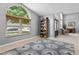 Comfortable living room with a large arched window, tiled flooring, and a cozy atmosphere at 1008 Soldier Creek Ct, Oviedo, FL 32765