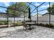 Charming screened-in patio with brick pavers and a table set perfect for outdoor dining and relaxation at 1008 Soldier Creek Ct, Oviedo, FL 32765