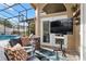 Covered patio area with comfortable seating, a television, and a view of the pool at 1008 Soldier Creek Ct, Oviedo, FL 32765