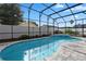 Inviting screened-in pool area with brick pavers and a beautiful blue kidney-shaped pool reflecting the sky above at 1008 Soldier Creek Ct, Oviedo, FL 32765