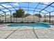 Inviting screened-in pool area with brick pavers, landscaping, and a beautiful blue kidney-shaped pool for relaxation at 1008 Soldier Creek Ct, Oviedo, FL 32765