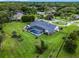 Aerial view of a home with a screened-in pool, a sprawling lawn and mature landscaping at 104 Amberwood Ct, Longwood, FL 32779