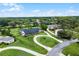 Aerial view of a home with a circular driveway, set amongst lush greenery and neighboring houses at 104 Amberwood Ct, Longwood, FL 32779
