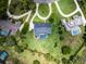Aerial view of a property outlined in red, featuring a screened pool and circular drive at 104 Amberwood Ct, Longwood, FL 32779