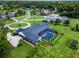 Aerial view of a house with screened pool, landscaping, and a long driveway at 104 Amberwood Ct, Longwood, FL 32779