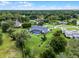 Sprawling property with a screened-in pool, lush lawn, and mature trees in a residential neighborhood at 104 Amberwood Ct, Longwood, FL 32779